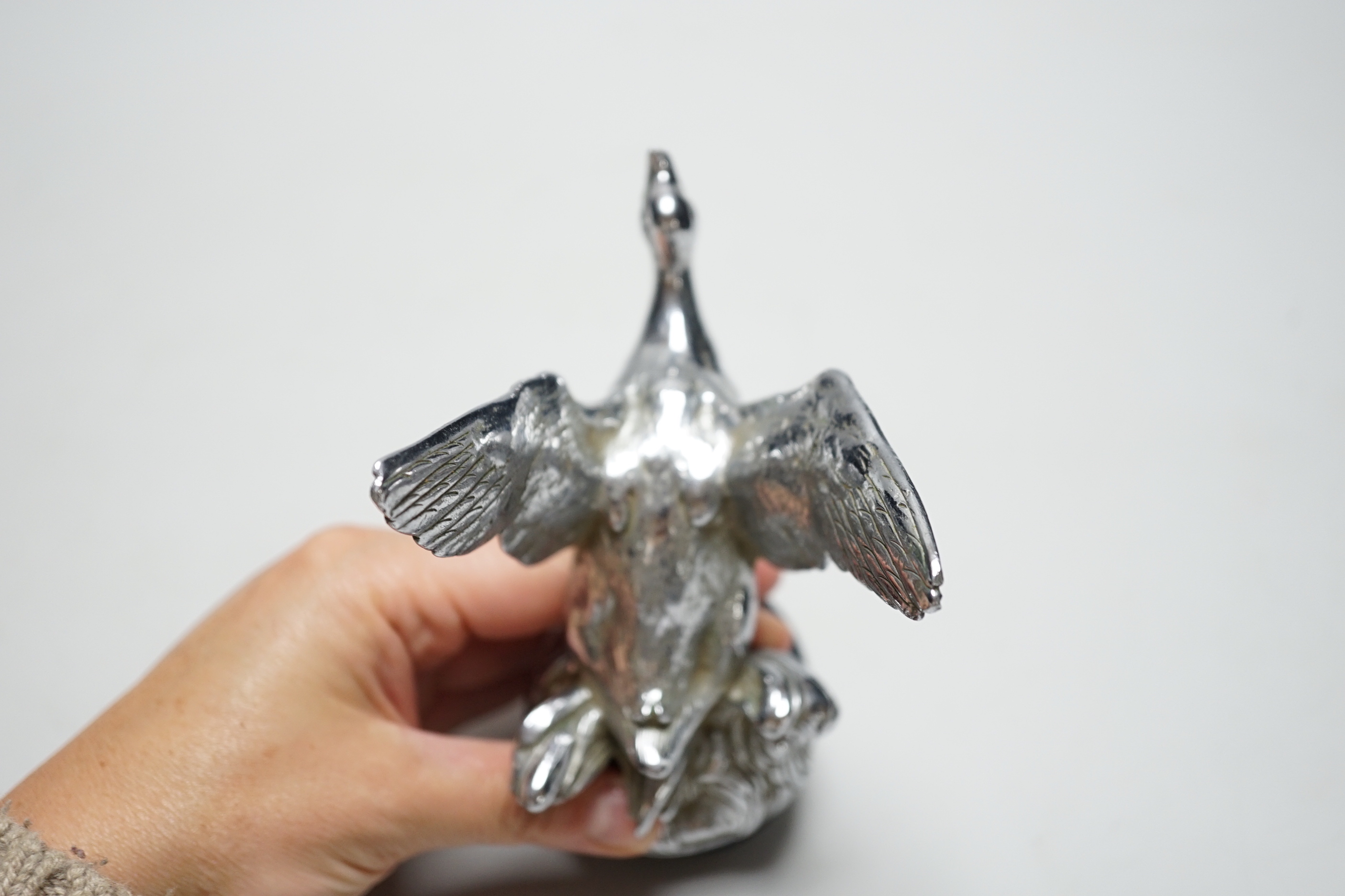 A chromium goose car mascot